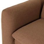 Zoomed detail of quilting and fabric texture on sofa arm and cushions