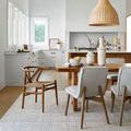 Sammy rug styled in a bright dining room under a wooden table and mix of wood and fabric chairs