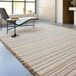 Rug angled in contemporary room showing fringed edge with chaise lounge and window light