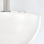 Close-up of glass edge showing smooth curved finish against the polished nickel detail