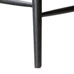 Bottom edge of front tapered leg with visible black wire-brushed wood grain texture