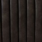 Close-up detail of rich leather texture and soft channeling stitches on sofa side