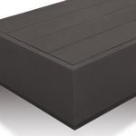 Angle close-up showing the top slatted surface and side seam details of the outdoor table