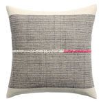 Handmade square pillow with natural beige and gray geometric grid pattern and a horizontal white and pink stitch detail