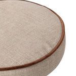 Close-up of the beige fabric cushion with contrasting brown piping detail on the stool’s seat