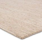 Angled close-up highlighting looped wool pile and cream-beige color variations