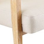 Close-up of cream upholstered seat cushion texture and wood frame