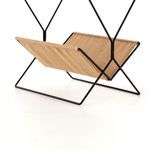 Side angle showing natural hemp fabric sling suspended between black metal rods on Monarch Magazine Rack