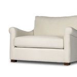 Alternate left angle of Bridges chair highlighting natural linen contrast and plush cushions