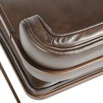 Detailed close-up of welted stitching and soft texture on brown leather backrest corner