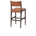 Angled view of stool showing depth of seat cushion and wood grain on frame