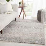 Living room setting featuring Cashel Tribal rug under modern sofa and cozy ottoman