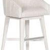 Side angle view of Ryder stool highlighting low profile curved back and silver footrest on white wood base