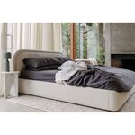 Echo Lamp on white marble side table by bed with charcoal gray sheets and neutral curtains