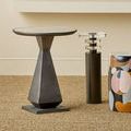 Janil Accent Table styled in a room setting with natural fiber carpet and decorative stools nearby