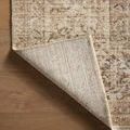 Rug corner flipped up exposing the underside textile and stitching details