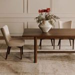 Side view of Posta dining chair paired with dining table, showing chair height relative to table edge