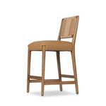 Bar stool angled side view highlighting balance of wood and upholstery