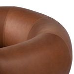 Close-up on the smooth leather texture of the rounded backrest