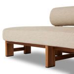 Side view close-up of teak arm support and rounded backrest cushion junction