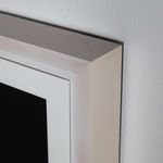 Close-up detail of whitewashed maple corner frame with crisp mitered edges and subtle wood grain