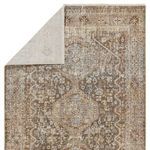 Back of rug partially folded, revealing light-colored backing with faint medallion pattern