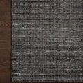 Corner of the Jamie Graphite Charcoal Rug on dark hardwood floor highlighting woven fiber pattern and color variation