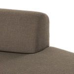 Close-up side angle of sofa backrest merging smoothly into seat cushion edge.