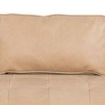 Close-up of padded button-tufted back cushion showing nude leather texture
