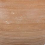 Close-up of terracotta base showing textured earth-toned surface with subtle white speckles