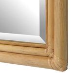 Close-up of mirror frame corner featuring tightly wrapped rattan weave in natural finish