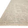 Priya Ivory / Grey Rug angled low view showing subtle geometric details and textured fringe on off-white background