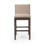 Front view of Wilmington Stool showing cushioned seat and back in beige fabric with almond wood frame