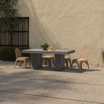 Kendall chair set of four arranged around concrete outdoor dining table on patio