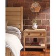 Close-up side view of Canyon Post Bed next to a matching wooden nightstand with decorative objects