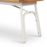 Detail of matte ivory metal bench leg with screws and foot pads