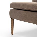 Detailed close-up of bottom edge upholstery aligned with tapered wooden leg