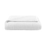 Side view of the throw blanket folded with sherpa backing partially visible along edge