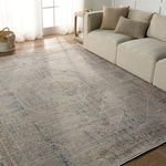 Rug styled in living room under natural light next to beige sofa and wooden side table
