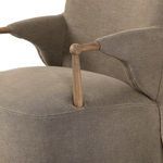 Detail view of oak arm connecting to the fabric slipcover on Brently Dining Chair