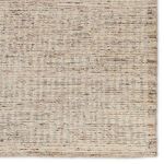 Close crop on rug showing detailed linear texture and color variation in striped pattern