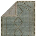 Rug flipped corner revealing gray woven backing with the medallion design visible