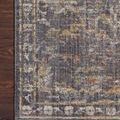 Close-up of rug corner on dark wood floor emphasizing pattern detail and edge binding