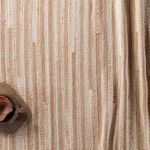 Close-up showing vertical striped variations with a wooden bowl on the corner of the rug