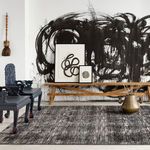 Rug in contemporary art styled room with black and white abstract wall art bench and decorative vase