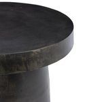 Side angle detail of table edge emphasizing thick, distressed bronze rim