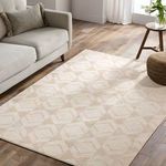 Rug styled in bright room next to beige sofa, showing full scale and modern decor