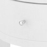 Detail shot focused on the conical brass drawer pull with polished finish