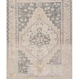Traditional rug with vintage distressed navy medallion and floral borders in light green, cream, gray, and tan tones