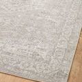 Top-down view of rug on wood floor showing overall pattern and soft, muted color palette